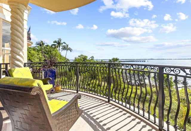 a view of a balcony with swimming pool and furniture