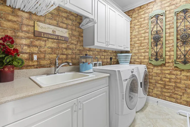 a bathroom with a sink a washer and dryer