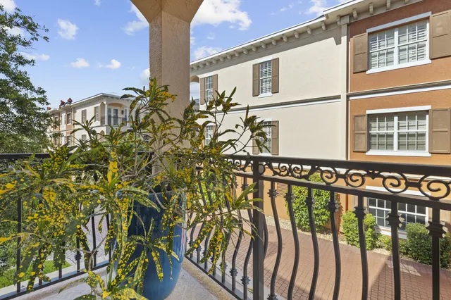 a view of a street with an entrance and plants