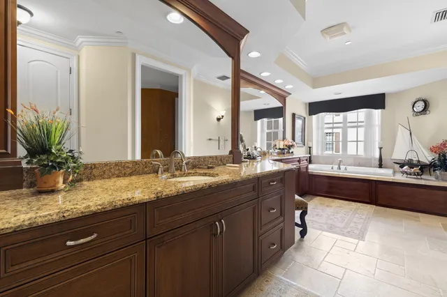 a spacious bathroom with a granite countertop sink a mirror and a