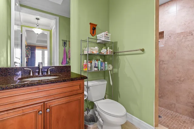 a bathroom with a toilet a sink and mirror