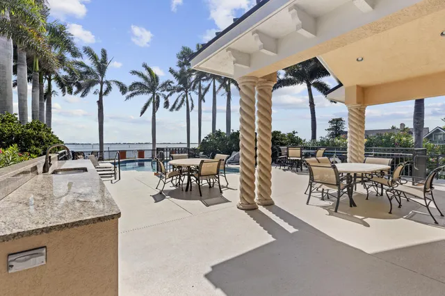 a view of a patio with a table and chairs