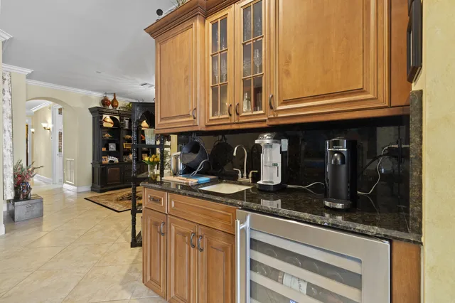 a kitchen with granite countertop a sink and cabinets