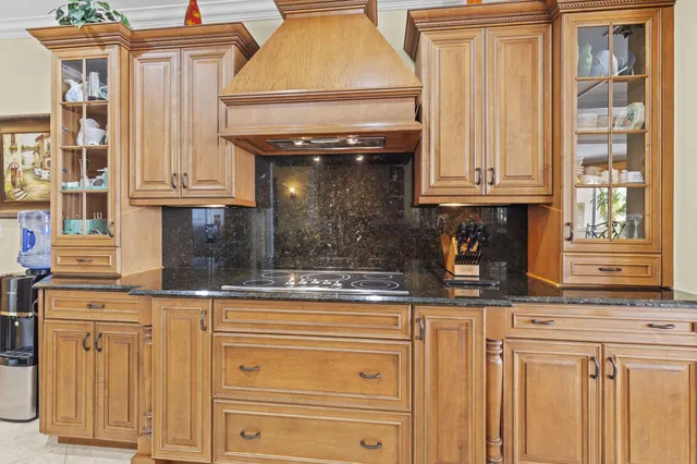 a kitchen with kitchen island granite countertop wooden cabinets and white appliances