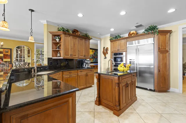 a kitchen with stainless steel appliances granite countertop a stove a refrigerator and a refrigerator
