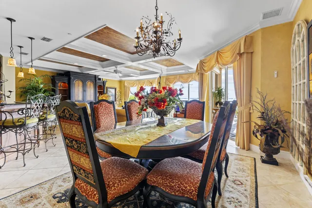 a view of a dining room with furniture and chandelier