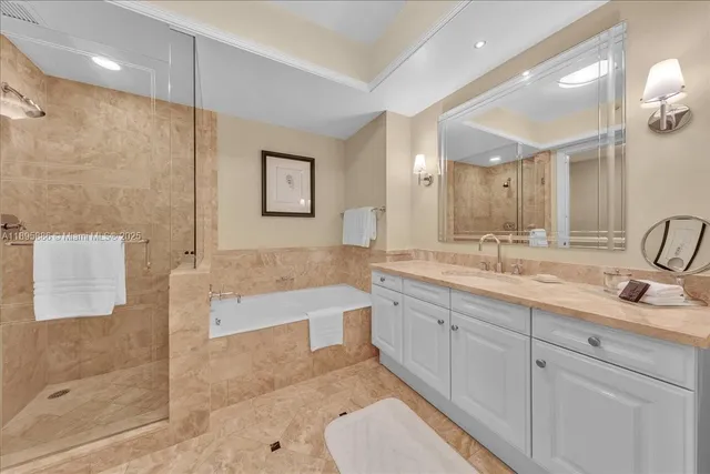 a bathroom with a tub sink and mirror