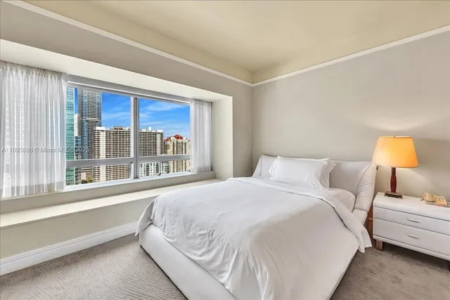 a kitchen with stainless steel appliances cabinets and a window