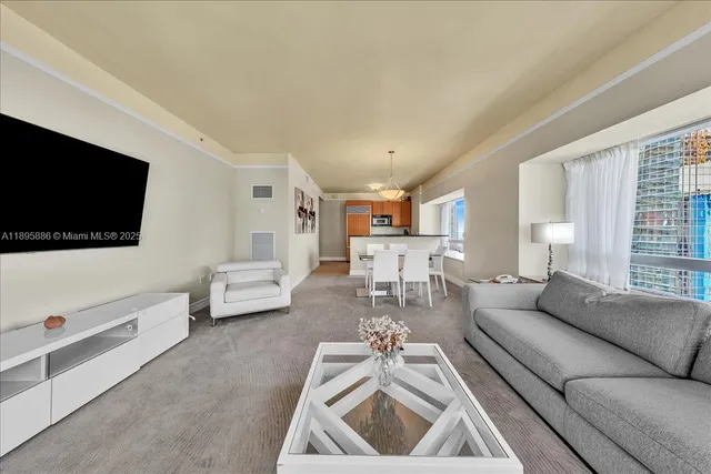 a living room with furniture and a large window