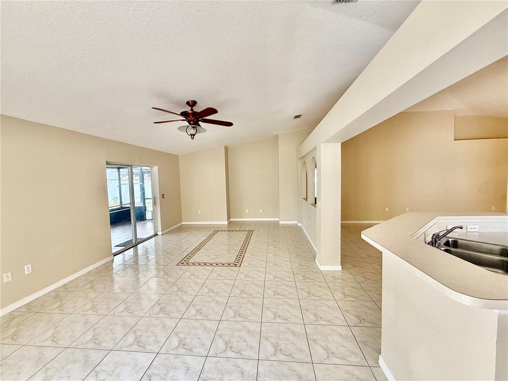 1346 Rolling River Road DeLand, FL 32720 - Photo 12 of 31 a view of a kitchen with a sink dishwasher a refrigerator freezer and a stove