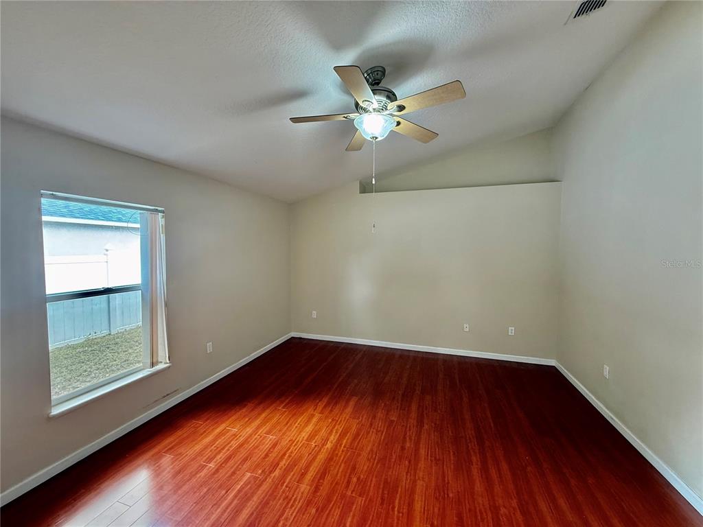 1346 Rolling River Road DeLand, FL 32720 - Photo 13 of 31 a view of empty room with wooden floor and fan