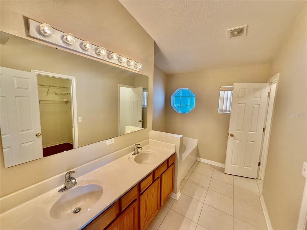 1346 Rolling River Road DeLand, FL 32720 - Photo 14 of 31 a bathroom with a sink a mirror and a toilet