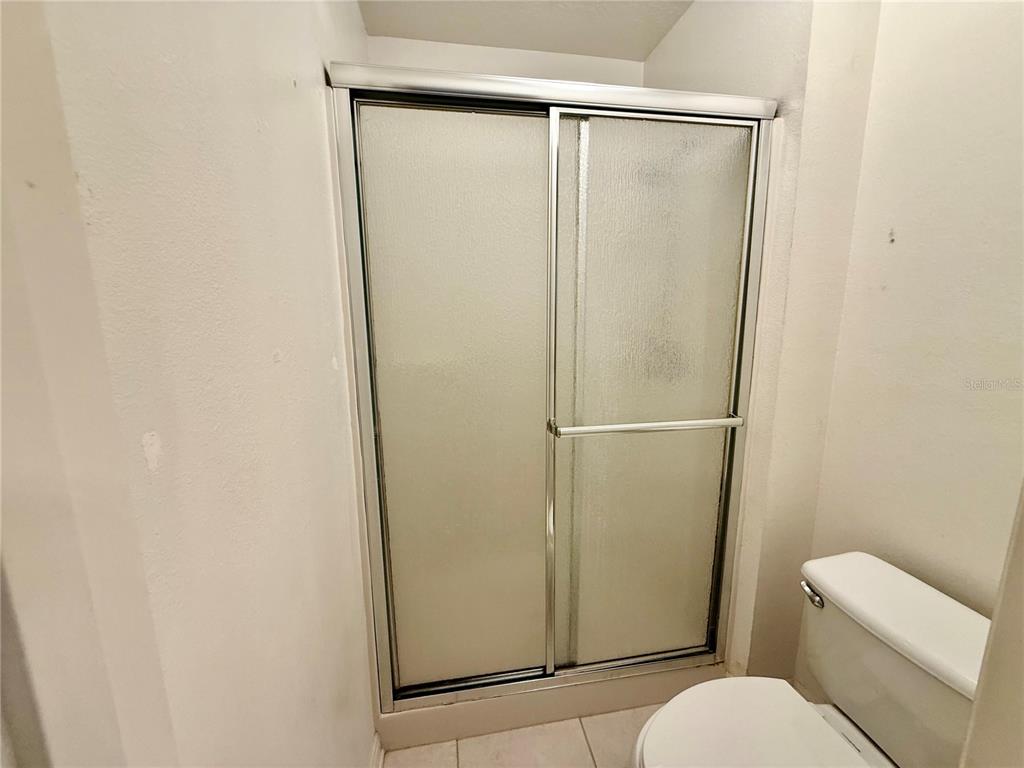 1346 Rolling River Road DeLand, FL 32720 - Photo 17 of 31 a bathroom with a glass shower door