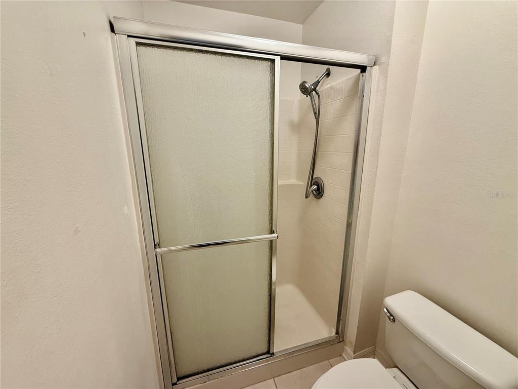 1346 Rolling River Road DeLand, FL 32720 - Photo 18 of 31 a bathroom with a granite countertop shower and toilet