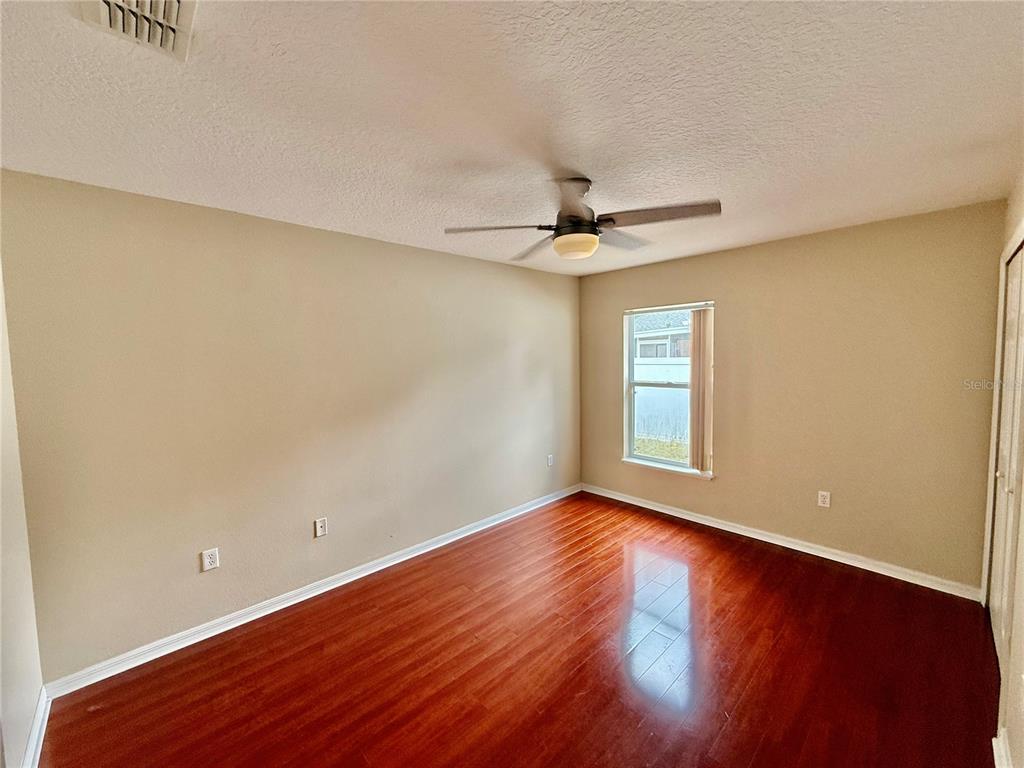 1346 Rolling River Road DeLand, FL 32720 - Photo 20 of 31 a view of an empty room with window and wooden floor