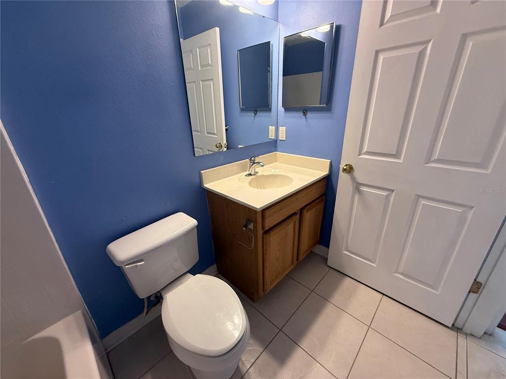 1346 Rolling River Road DeLand, FL 32720 - Photo 21 of 31 a bathroom with a toilet a sink and mirror