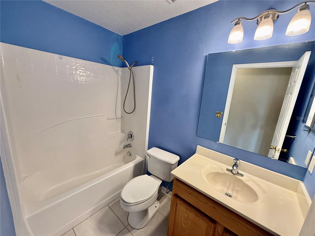 1346 Rolling River Road DeLand, FL 32720 - Photo 22 of 31 a bathroom with a sink toilet and shower