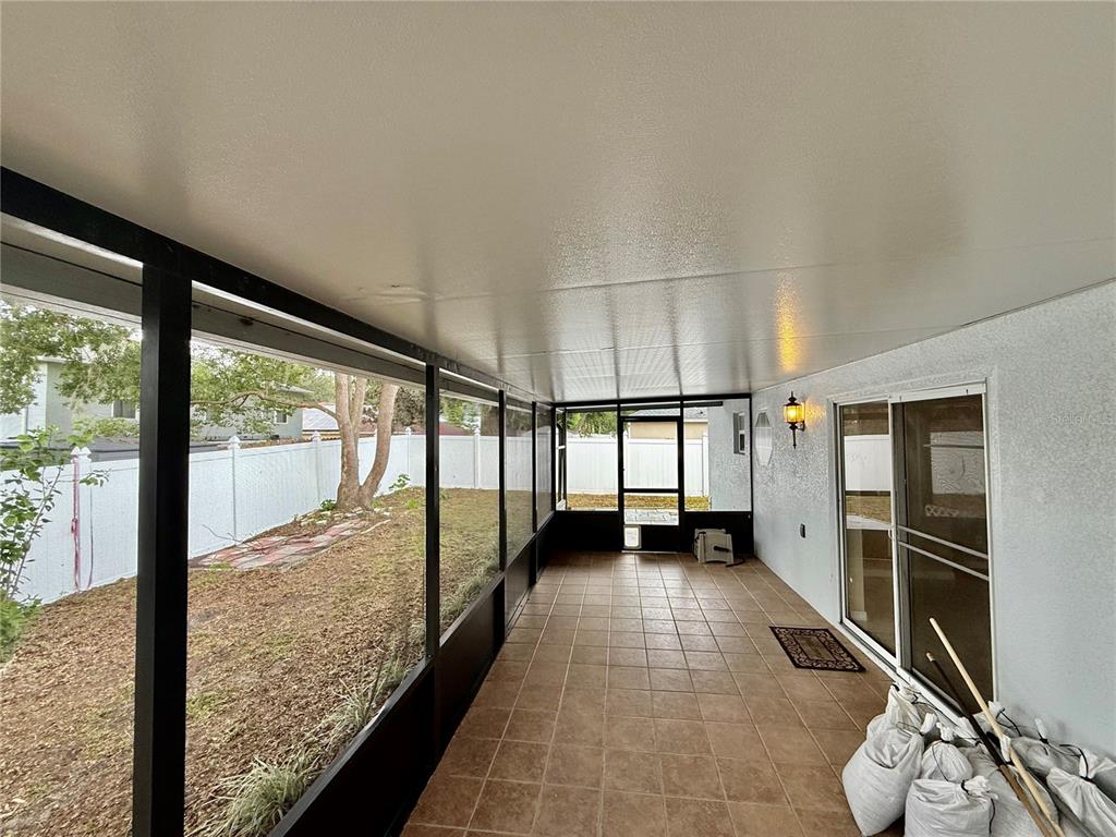 1346 Rolling River Road DeLand, FL 32720 - Photo 25 of 31 a view of a room with gym equipment and large windows