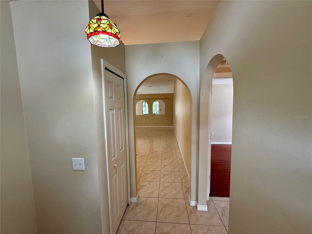 1346 Rolling River Road DeLand, FL 32720 - Photo 4 of 31 a view of a hallway with wooden floor