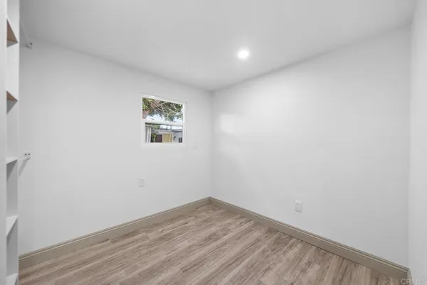 a view of room with wooden floor and window
