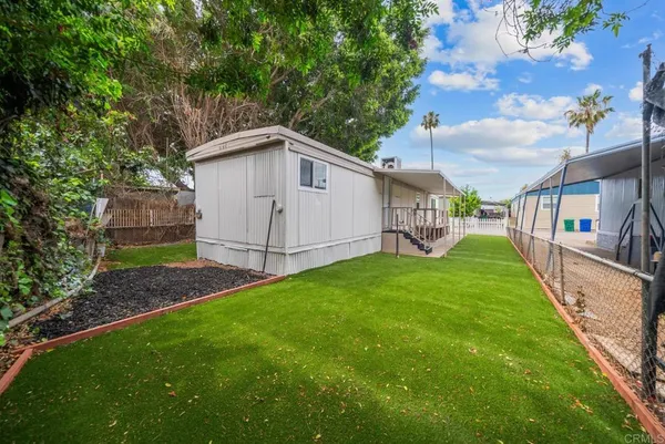 a view of a house with a yard and a garden