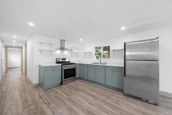 a kitchen with a refrigerator sink and cabinets