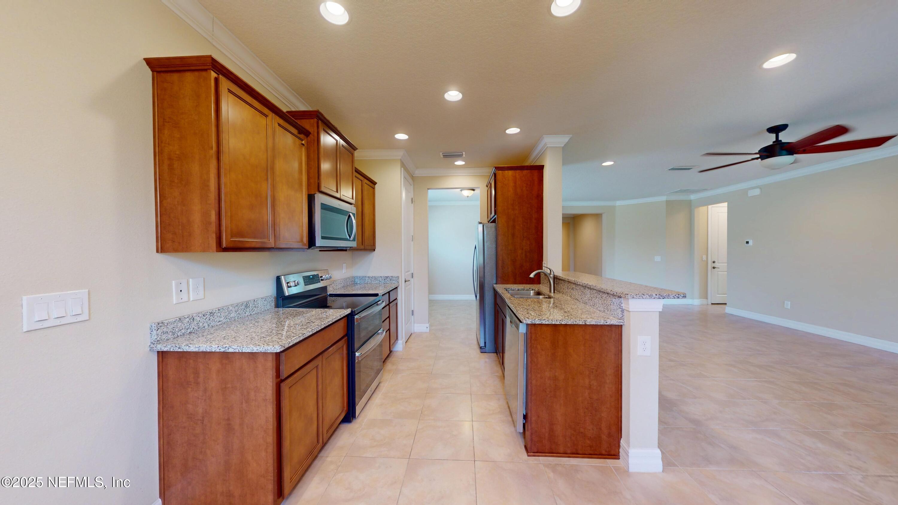 29 Lakefront Lane St. Augustine, FL 32095 - Photo 12 of 32 a kitchen with stainless steel appliances granite countertop a sink stove and refrigerator