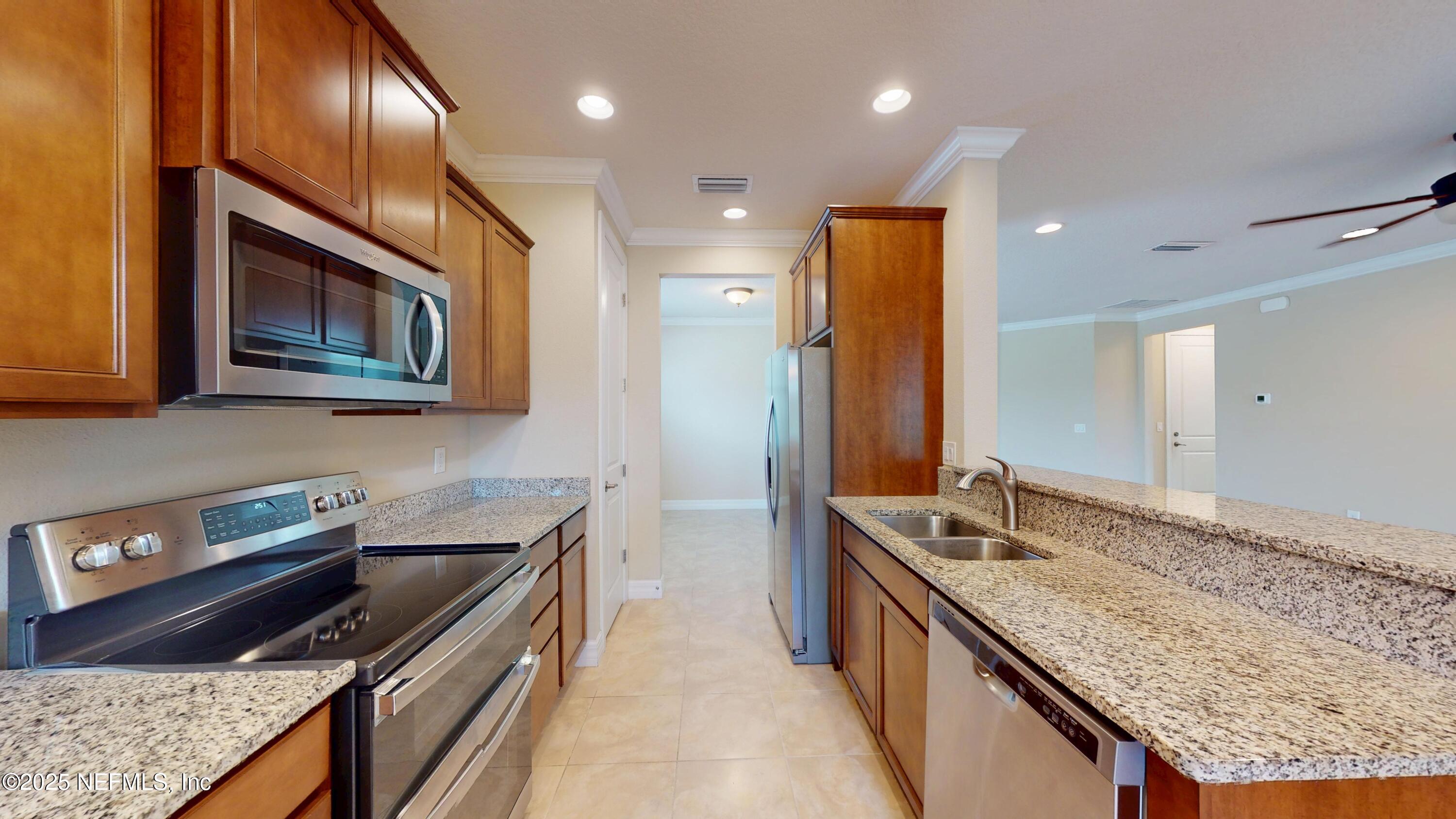 29 Lakefront Lane St. Augustine, FL 32095 - Photo 13 of 32 a kitchen with stainless steel appliances granite countertop wooden cabinets and a granite counter tops