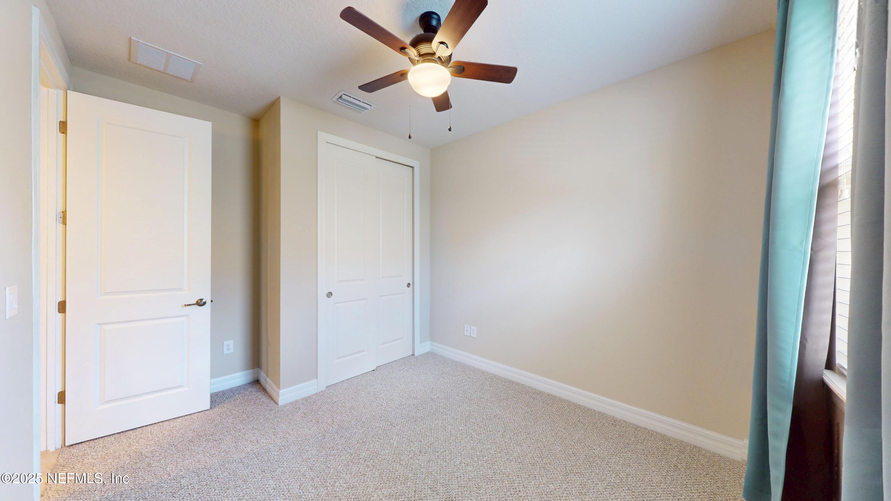 29 Lakefront Lane St. Augustine, FL 32095 - Photo 16 of 32 an empty room with closet and a ceiling fan