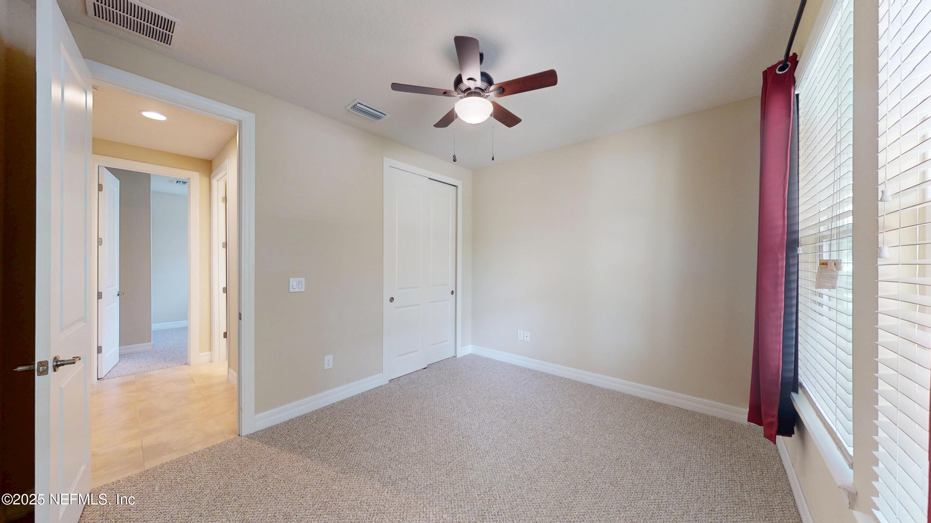 29 Lakefront Lane St. Augustine, FL 32095 - Photo 18 of 32 wooden floor in an empty room with a window