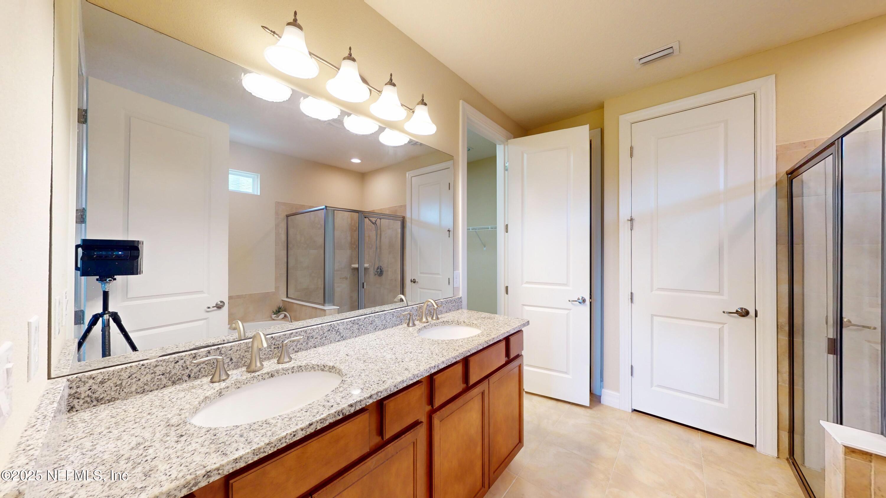 29 Lakefront Lane St. Augustine, FL 32095 - Photo 21 of 32 a bathroom with a granite countertop sink and a mirror