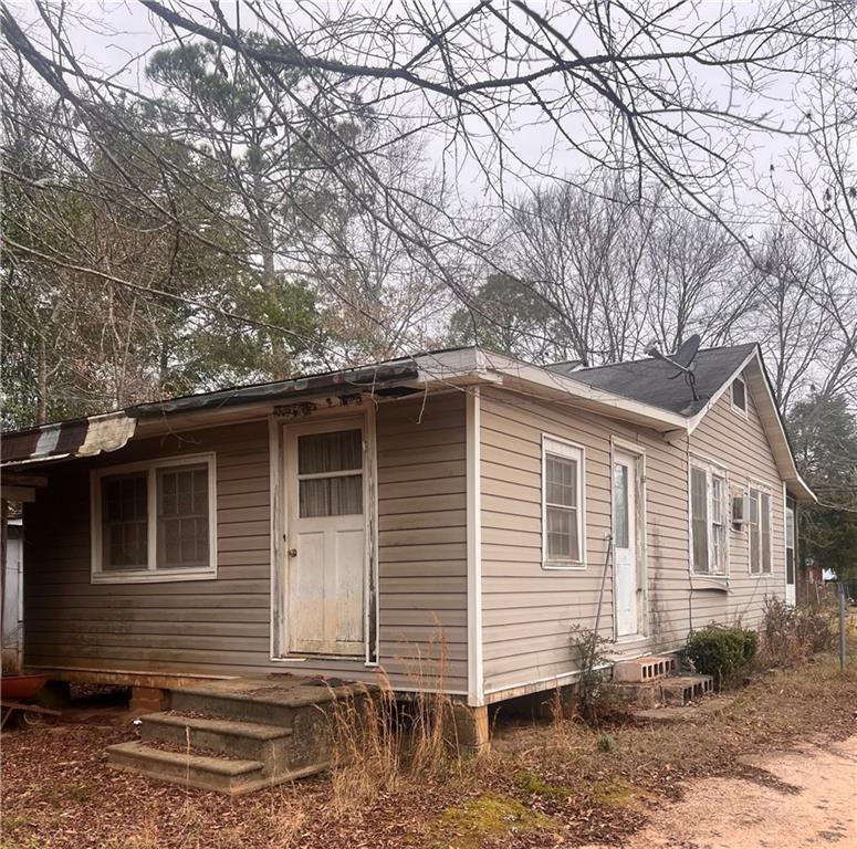 96 Jesse Johnson Street Blakely, GA 39823 - Photo 3 of 6 a front view of a house with garden