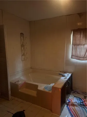 a front view of a house with yard and trees in the background