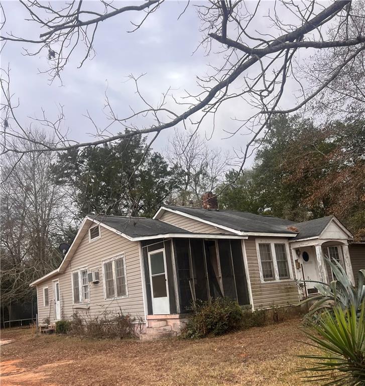96 Jesse Johnson Street Blakely, GA 39823 - Photo 5 of 6 a front view of a house with yard and trees in the background