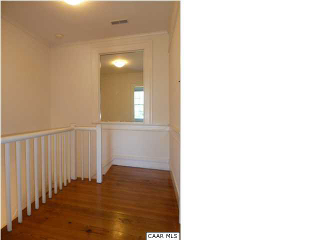 803 Valley View Road Ruckersville, VA 22968 - Photo 13 of 21 a view of a hallway with wooden floor and a bathroom