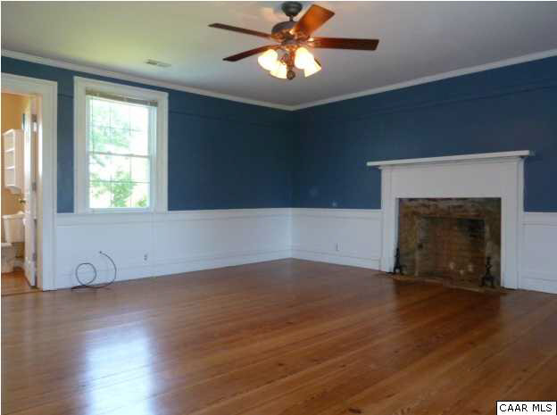 803 Valley View Road Ruckersville, VA 22968 - Photo 5 of 21 an empty room with wooden floor a chandelier fan and windows