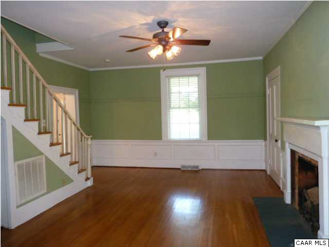 803 Valley View Road Ruckersville, VA 22968 - Photo 10 of 21 a view of an empty room with wooden floor fireplace and a window
