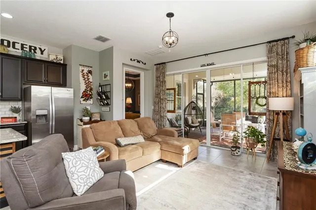 a kitchen with stainless steel appliances kitchen island granite countertop a stove top oven a sink dishwasher a dining table and chairs with wooden floor