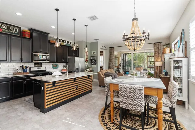 a kitchen with a sink a counter and chairs