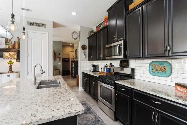 a bathroom with a double vanity sink and mirror with shower