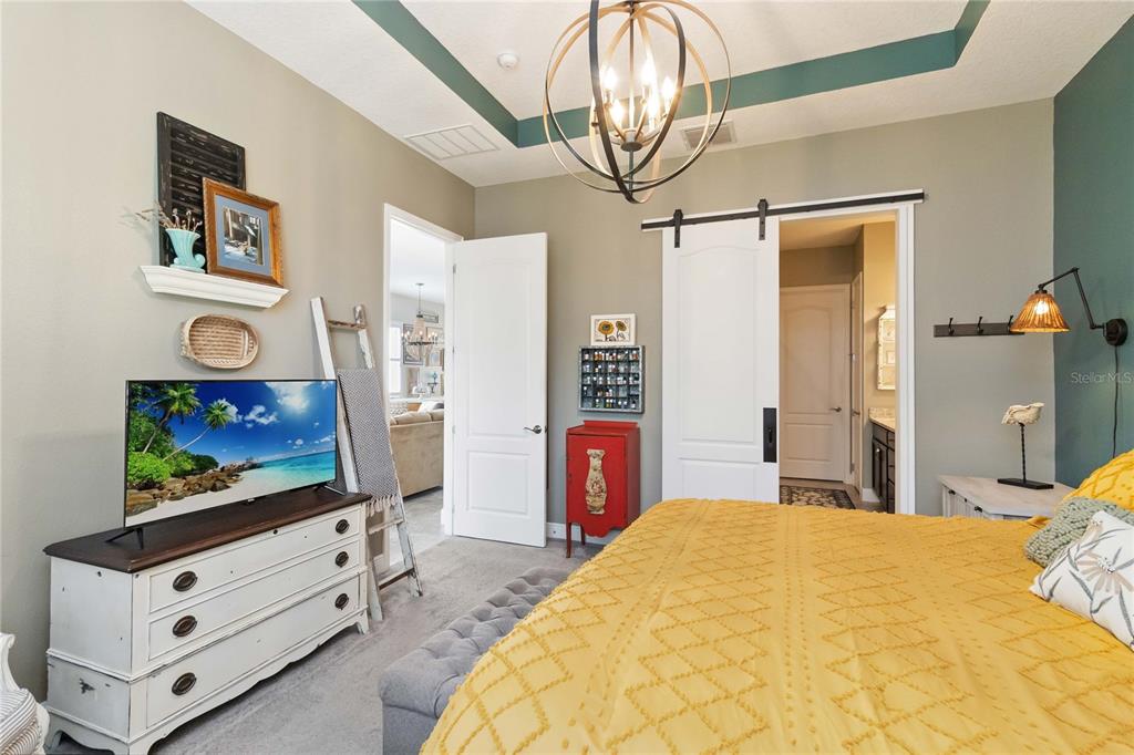 2463 Datura Loop St. Cloud, FL 34772 - Photo 21 of 57 a bedroom with a bed and a flat screen tv