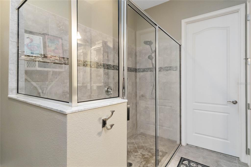 2463 Datura Loop St. Cloud, FL 34772 - Photo 25 of 57 a bathroom with a glass shower door