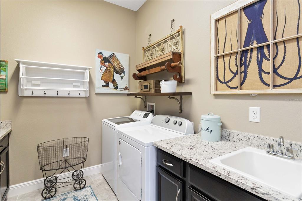 2463 Datura Loop St. Cloud, FL 34772 - Photo 29 of 57 a utility room with a sink a washer and dryer