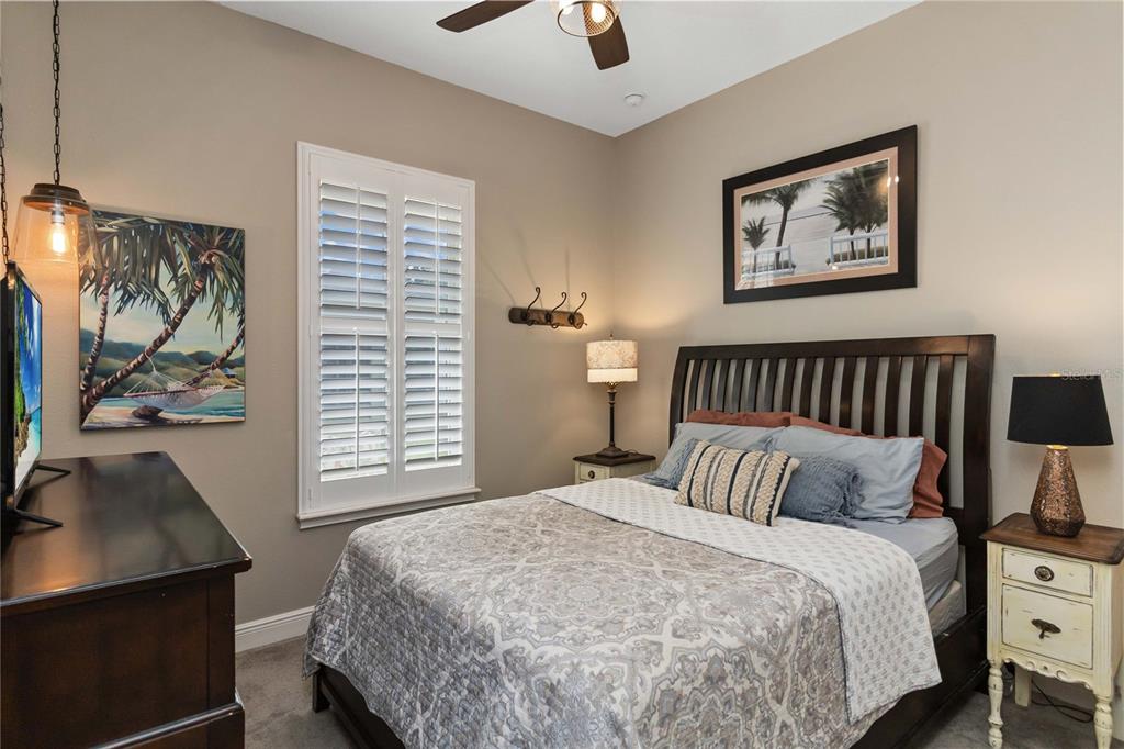 2463 Datura Loop St. Cloud, FL 34772 - Photo 31 of 57 a bedroom with a bed and a flat tv screen on the dresser