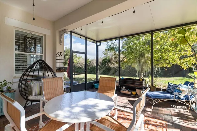 a front view of house with yard and trees in the background