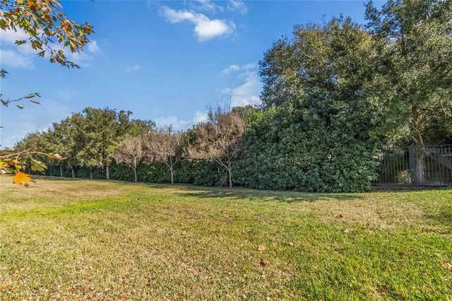 an aerial view of a house with a garden and lake view