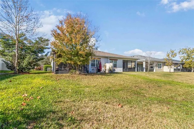 a living room with fireplace furniture and a large window