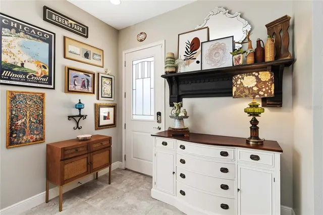 a living room with furniture a kitchen view and a chandelier