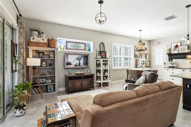 a living room with furniture windows and a flat screen tv
