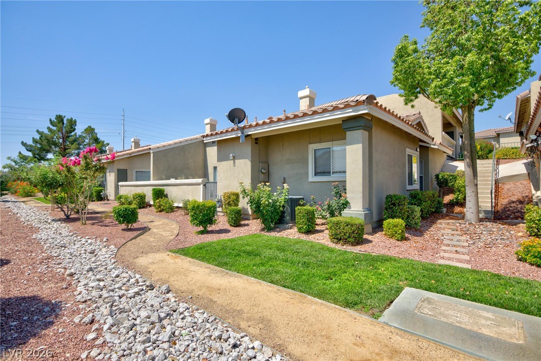 3238 Mystic Ridge Court Las Vegas, NV 89129 - Photo 22 of 31 A quaint pathway winds through a neatly landscaped front yard, leading to a charming residence.